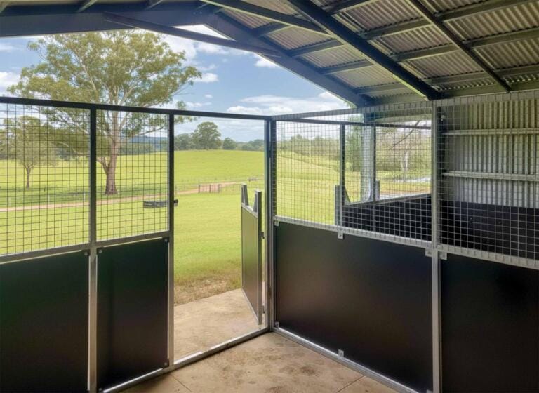 Open stable door overlooking lush green paddocks.