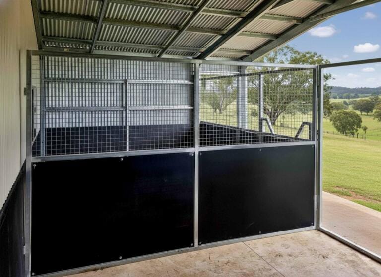Horse stable with open countryside view.