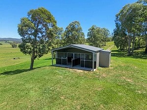Steel two-bay horse stable with three-panel yoke gates and reinforced ply lining inside a converted rural shed
