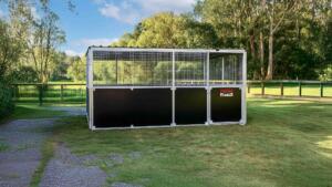 Front view of Animal shelter anchored on grass field.