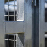 Close-up of metal fence joints outdoors