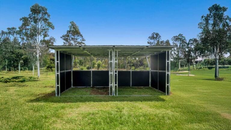 Twin Bay Paddock Shelter on grass paddock with Augured cement anchors