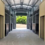 Walk-through breezeway stable retrofit with opposing horse stalls