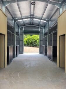 Walk-through breezeway stable retrofit with opposing horse stalls