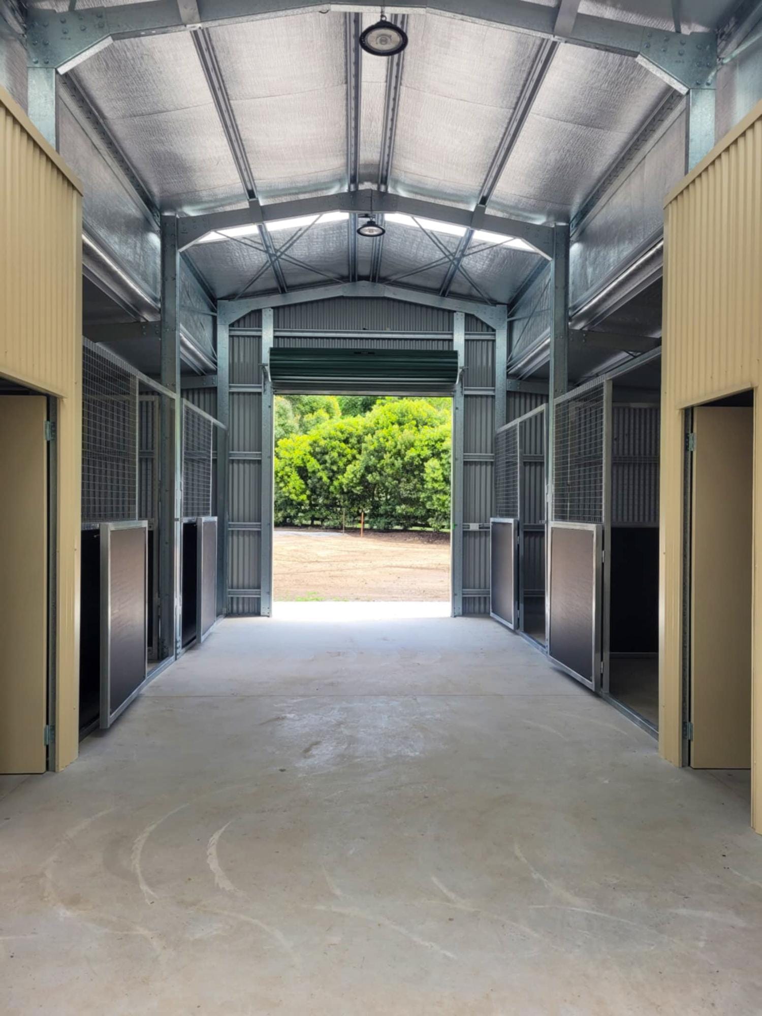 Walk-through breezeway stable retrofit with opposing horse stalls