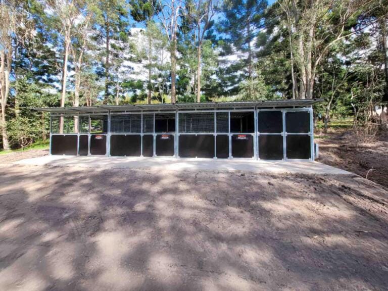 Horse stables surrounded by trees in Australia.