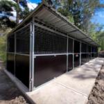 High-resolution front-left angle of completed 3-bay horse stable with integrated tack room – showcases durable steel build, mesh airflow panels, and professional finish on a rural property.