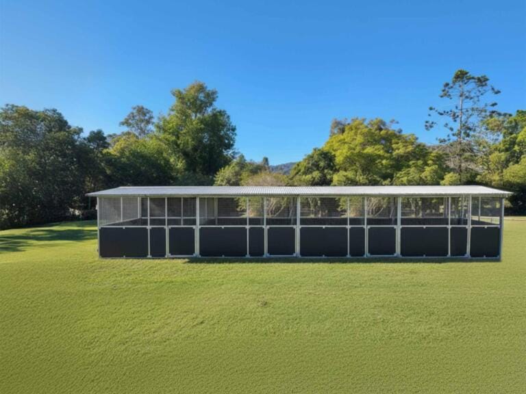 Outdoor structure on grassy field with trees behind.