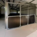 Interior of metal horse stable in shed