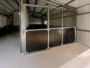 Interior of metal horse stable in shed