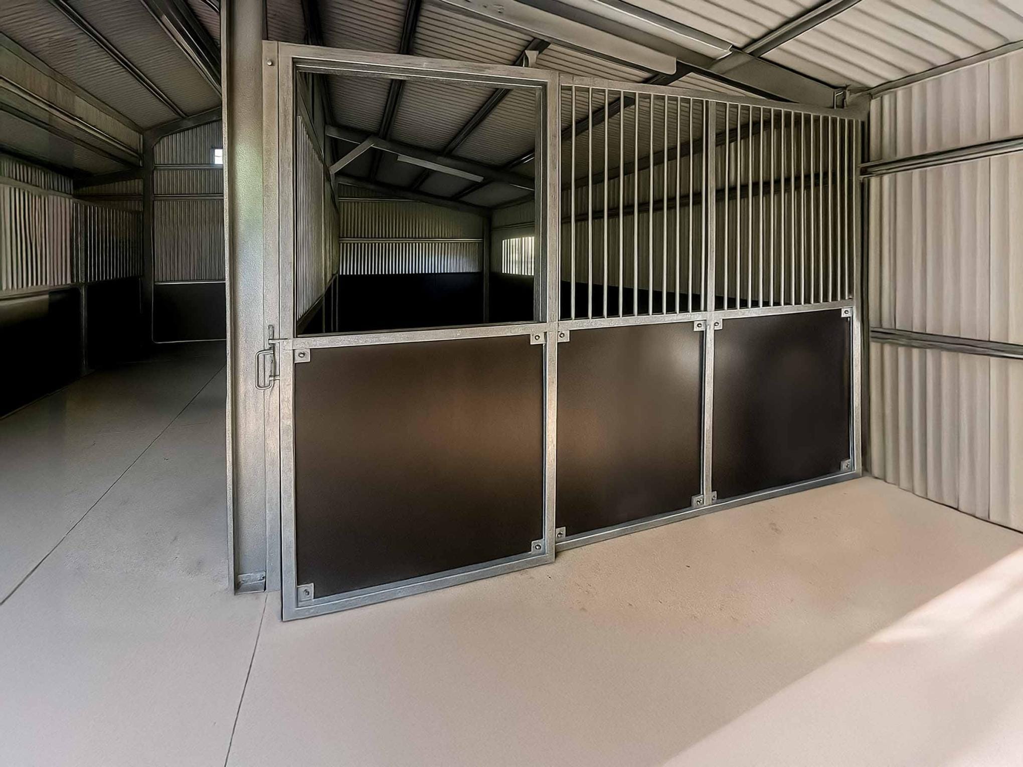 Interior of metal horse stable in shed
