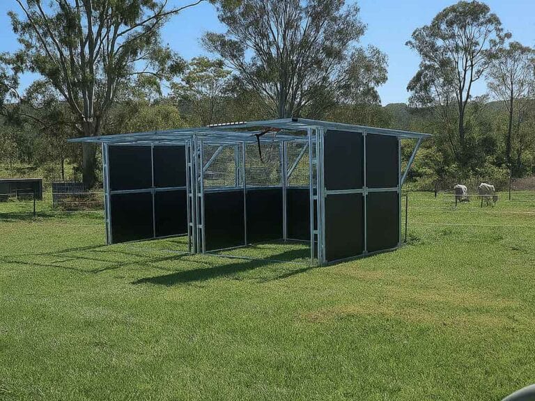 Portable horse shelter on grassy field, sunny day.