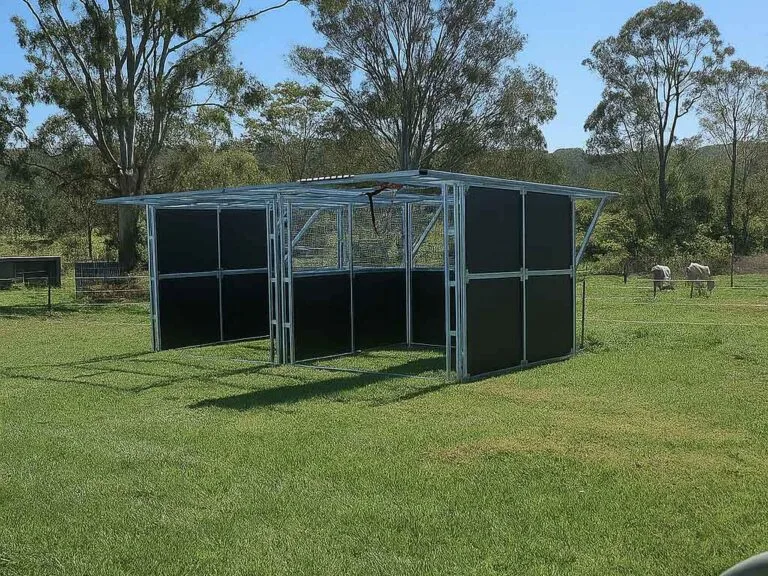 Portable horse shelter on grassy field, sunny day.