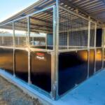Steel horse stables with durable fencing.