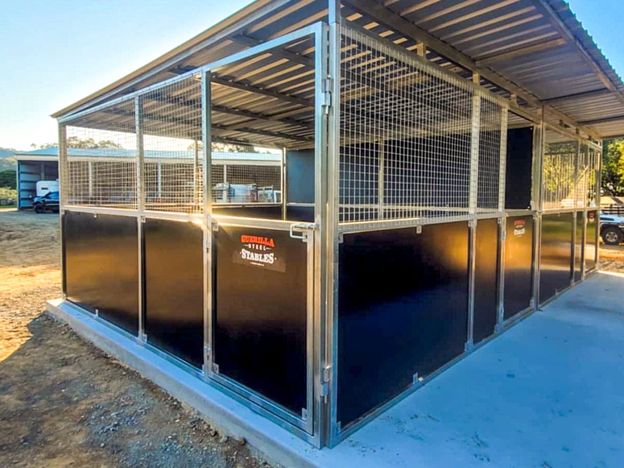 Steel horse stables with durable fencing.
