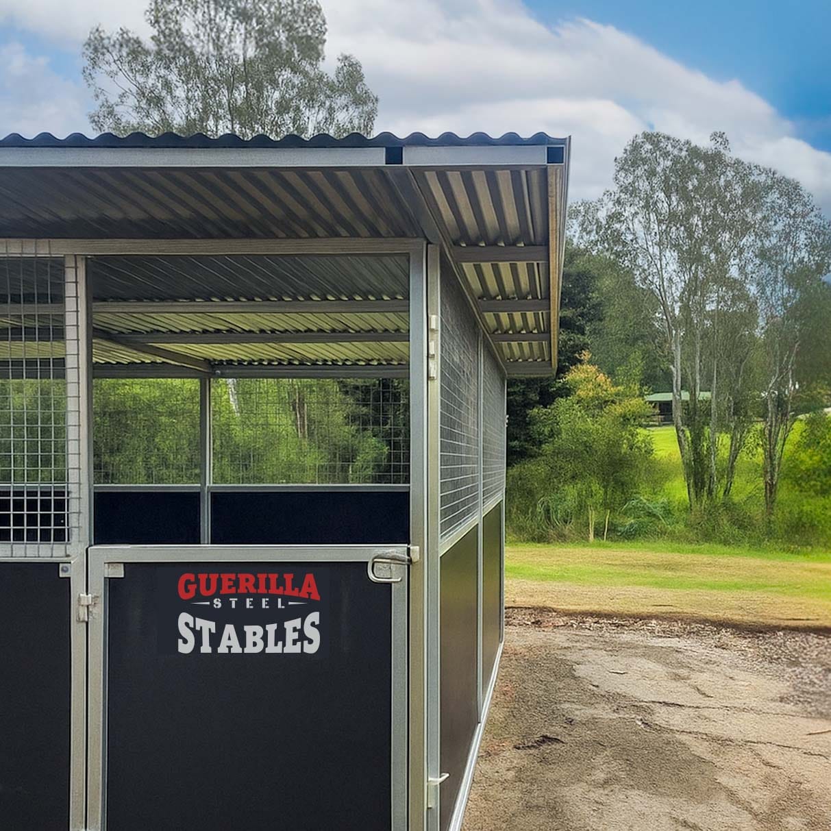 Modern steel horse stables in rural setting.
