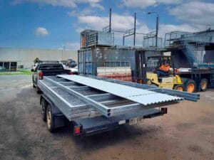 Loading Flat pack stable kit into trailer at the Yatala Fabrication Workshop