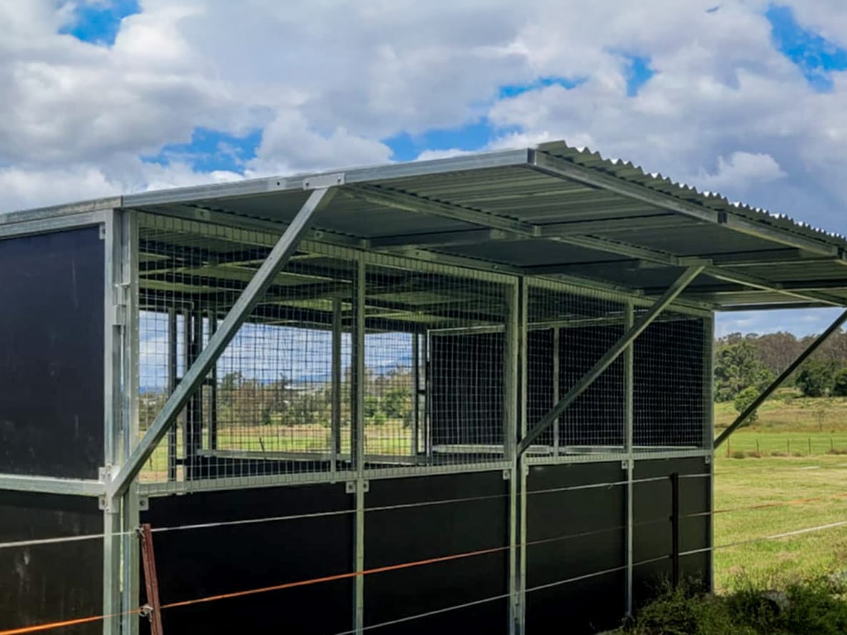 Metal livestock shelter in a rural paddock