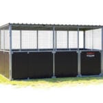 Outdoor steel animal enclosure with wire mesh panels.