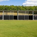 Visualisation wide angle view of 4 Bay Stable installed on grass paddock
