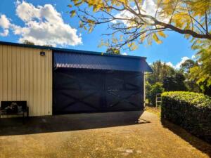 black modular horse stalls with dutch doors and central divider breezeway stable design
