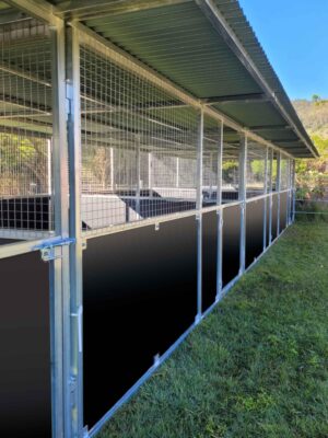 Close-up of Samford Valley QLD, galvanised steel horse stable framing and mesh panels along stable aisle, showing precision alignment and airflow detailing - Guerilla Steel Built