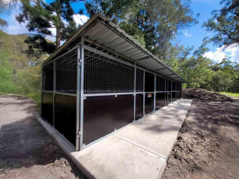 High-resolution front-left angle of completed 3-bay horse stable with integrated tack room – showcases durable steel build, mesh airflow panels, and professional finish on a rural property.