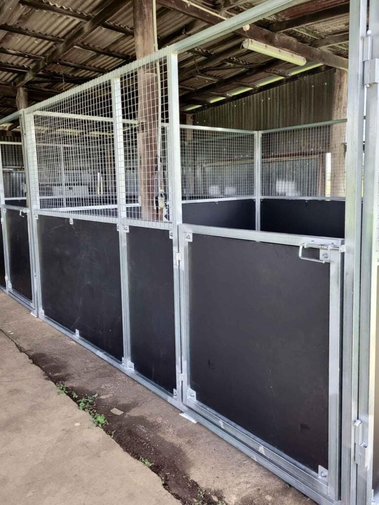 Horse stable with metal and wood walls