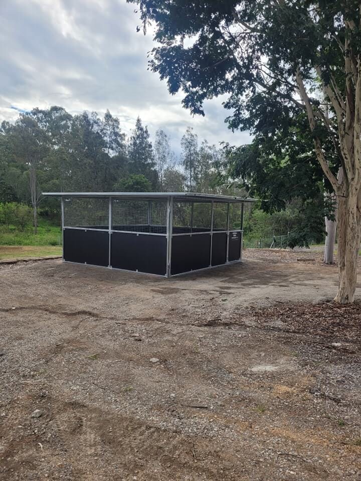 Single-bay horse stable on compacted ground with welded steel frame and mesh-top ventilation.