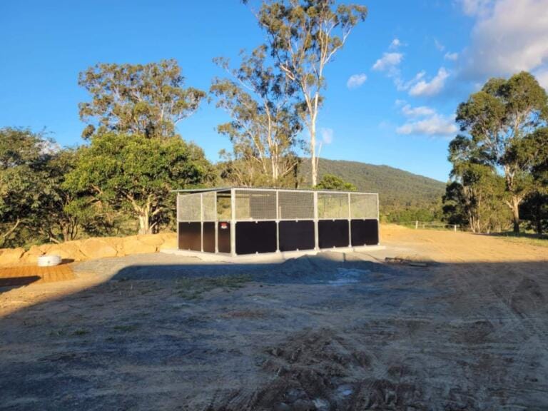 Rural solar installation with trees and hills view.