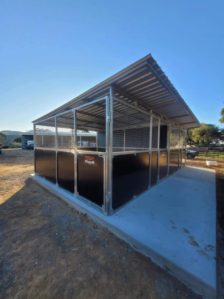 Outdoor steel stables on concrete slab