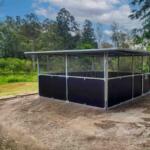 Side view Guerilla Steel horse stable in Samford Valley showing extended roof span, mesh ventilation panels and welded steel frame.