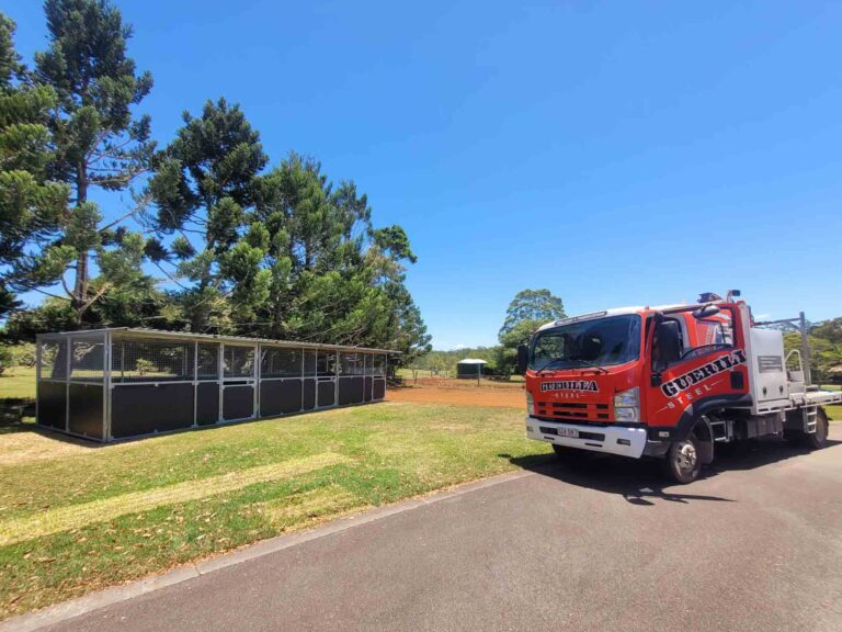 Completed three Bay Modular Horse Stable with mesh panels and ply kickboards in paddock with Guerilla Steel Delivery Truck