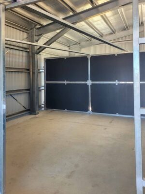 fully enclosed horse stable bay inside steel shed with solid ply panels