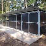 finished 3 bay horse stable with tack room built from galvanised steel and mesh panels on concrete slab