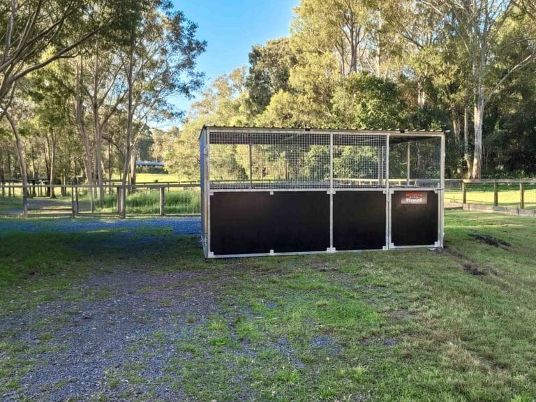 Custom steel dog pen with mesh upper panels and half height swing gate