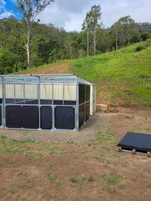 3 bay modular horse stable with mesh panels and HDPE kickboards on rural hillside property